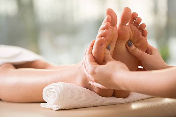 close up of young woman having reflexology